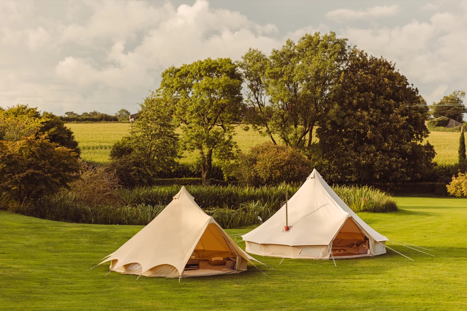 Bell tents lit with festoon lights in the evening near Bath