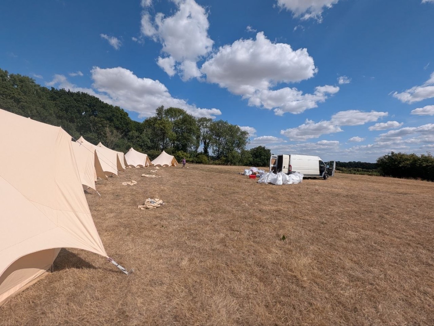 Camp Chic van and kit during bell tent set-up on hard late-summer ground
