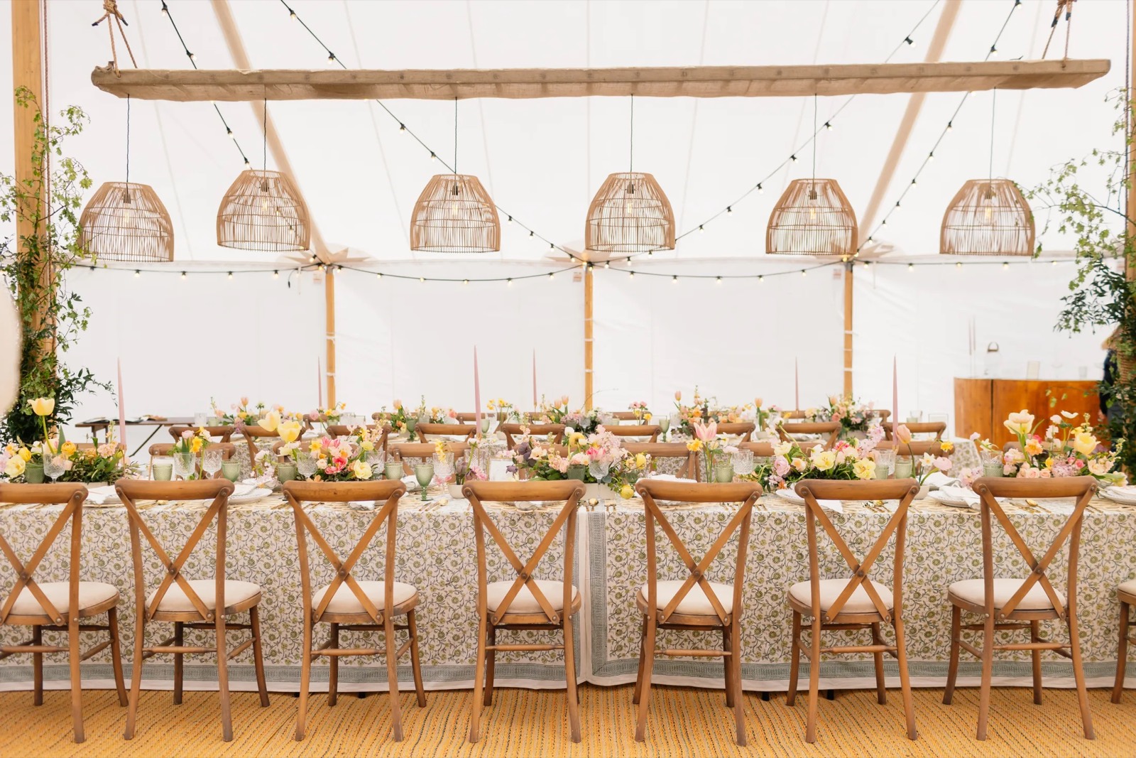 Styled bell tent interior with made-up bed for wedding guests