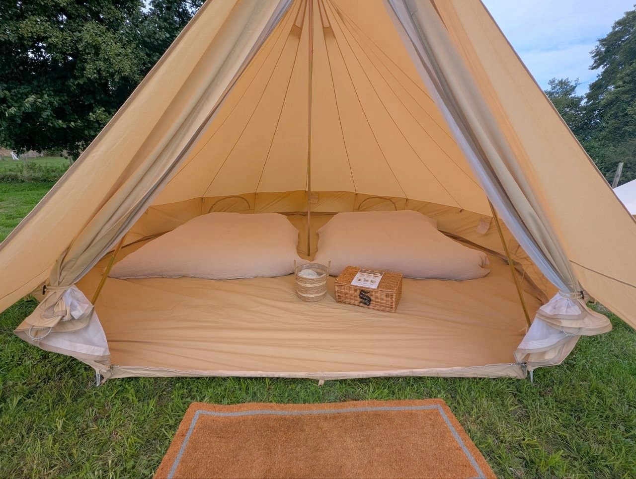 Two made-up king-size airbeds side by side inside a bell tent at the Frome wedding