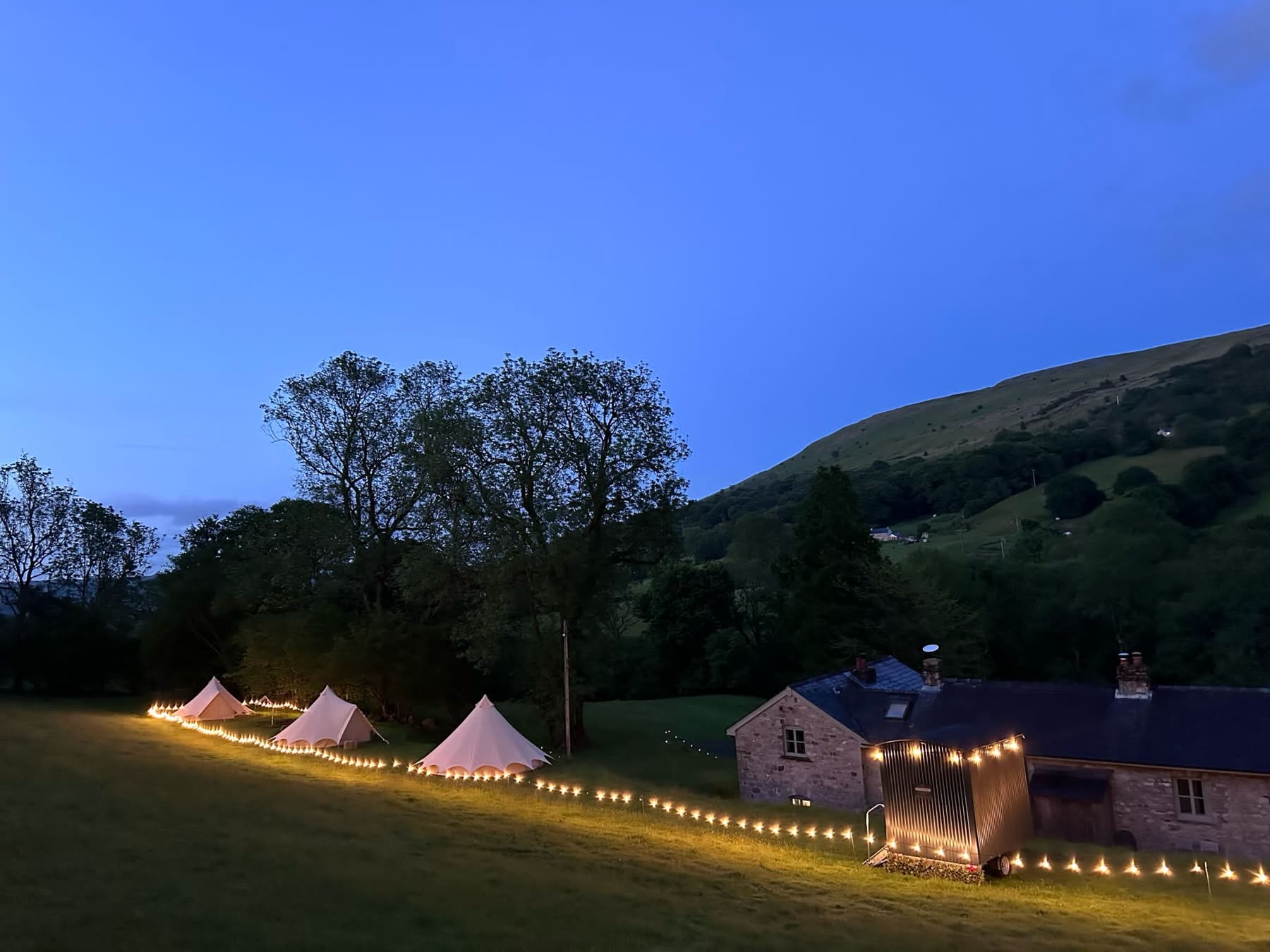 Camp Chic bell tents in a green rural Abergavenny setting with South Wales hills in the background