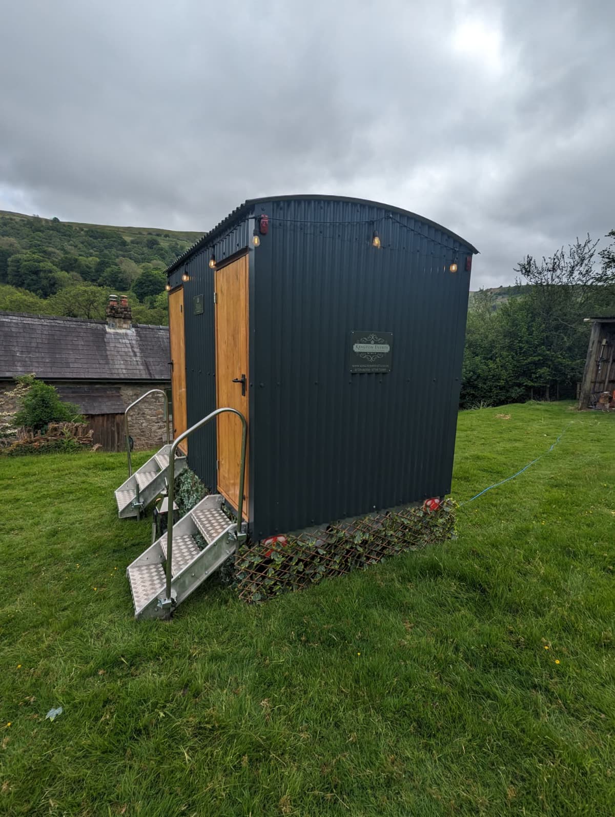 Kington Events toilet cubicle beside a private Abergavenny event site with Camp Chic bell tent accommodation