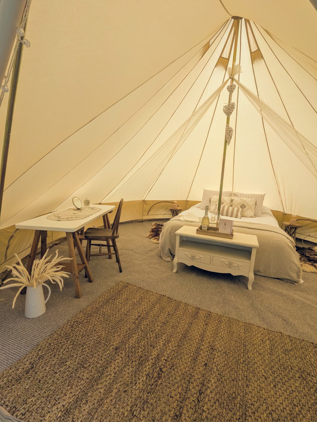 Styled furnished Camp Chic bell tent interior with double bed for a Wiltshire wedding