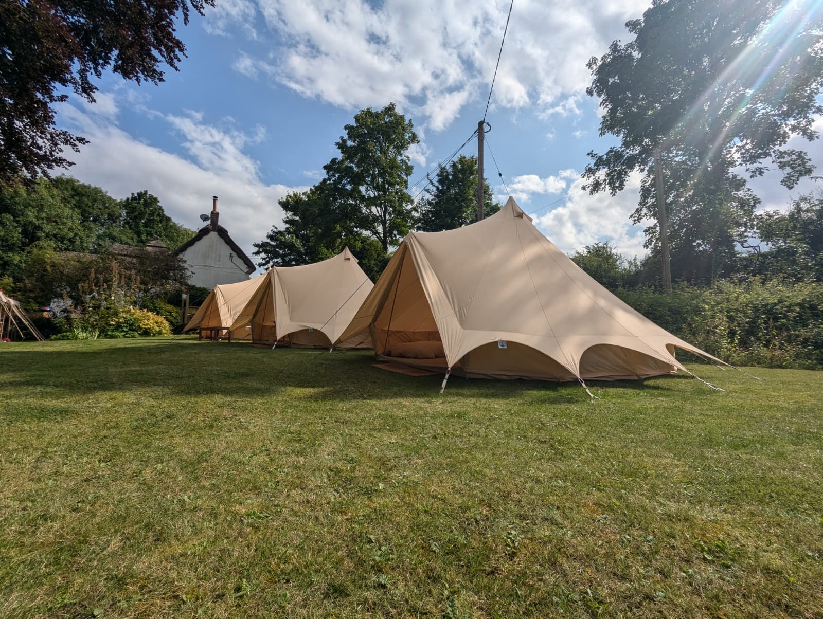 Camp Chic bell tents set up on private land in Sherrington Wiltshire for wedding guest accommodation
