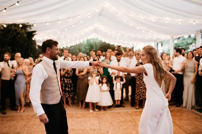 Dancing beneath marquee festoon lights
