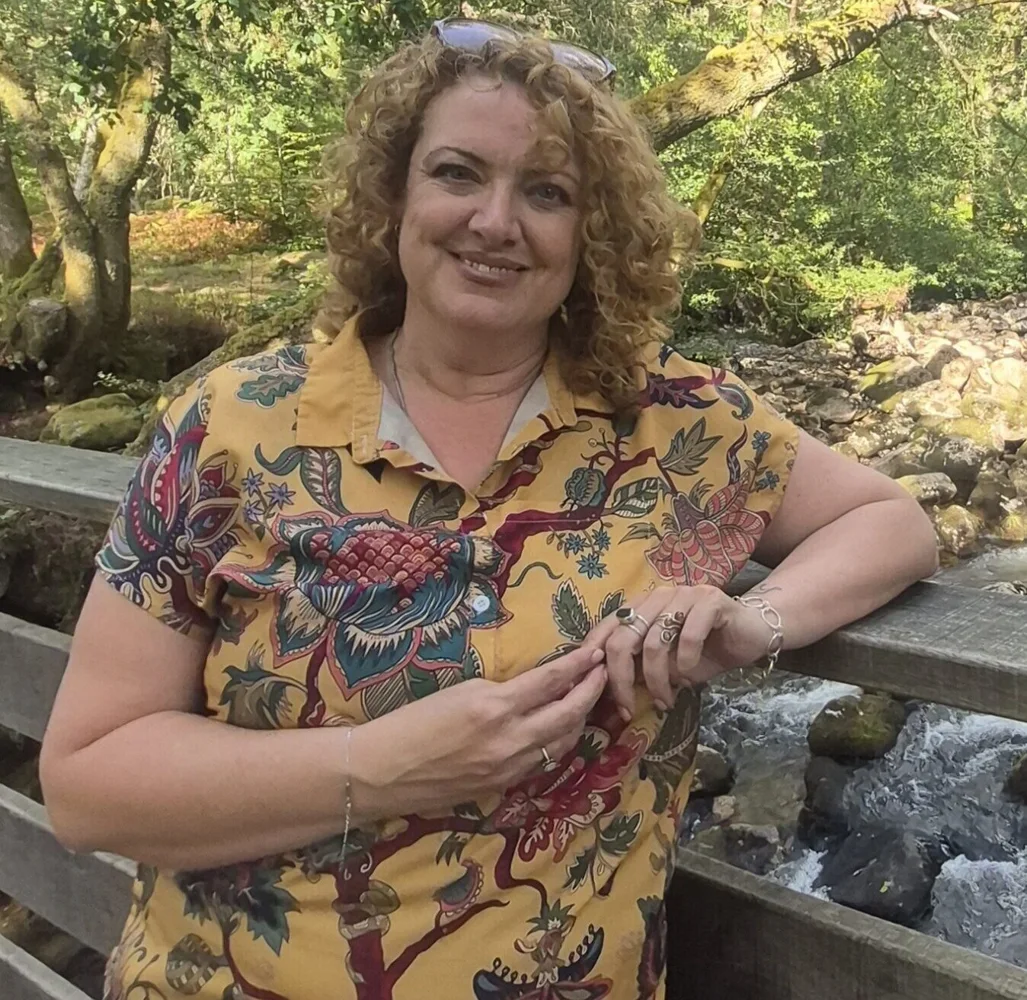 Melly outdoors beside a bridge