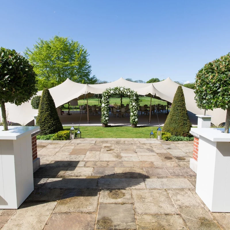 Hurlingham Wessex stretch tent in a garden setting